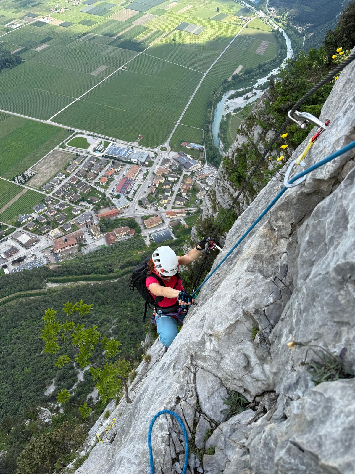 A climber on a steep, exposed limestone via ferrata.